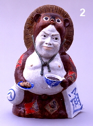 Tanuki holding tea cup and cookies