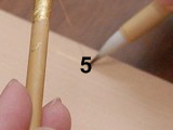 Applying kirikane using glue, or rice paste, or lacquer.