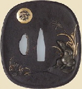 Tsuba (sword guard) with design of a tanuki drumming on its belly beneath the moon. Japanese, Mid-19th Century. MFA Collection.
