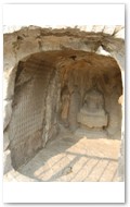 Binyang Middle Caves, 500 to 523 AD. Multiple miniature Buddha carved in wall face.