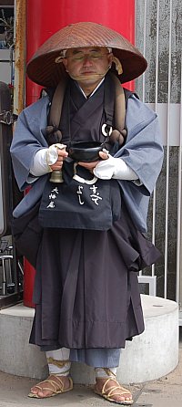 Buddhist Monk Begging for Donations to Help the Disaster Zone