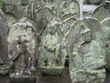 Stone carvings including Nyo-irin Kannon, at Zenyo-in in Inatori City