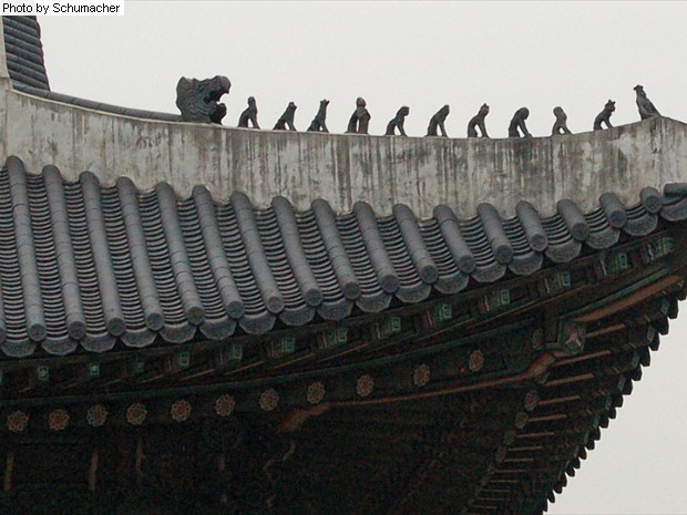 Roof tiles at Gyeongbokgung Palace, Seoul, Korea. The protective rooftop effigies come in various configurations, including groups of three, five, six, seven, and eleven, and meant to protect against fire.